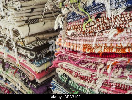 Colourful textile rugs or blankets displayed on street market in Marrakesh, Morocco - closeup detail Stock Photo