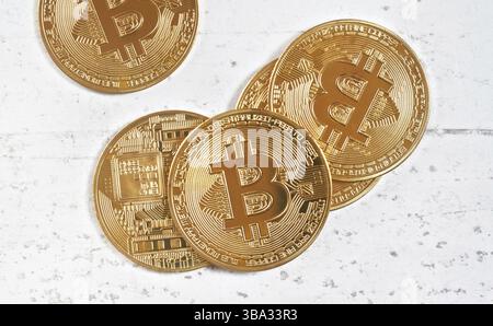 Top down view, golden commemorative btc - bitcoin cryptocurrency - coins scattered on white stone board, closeup detail, Liptovsky Hradok, Slovakia, E Stock Photo