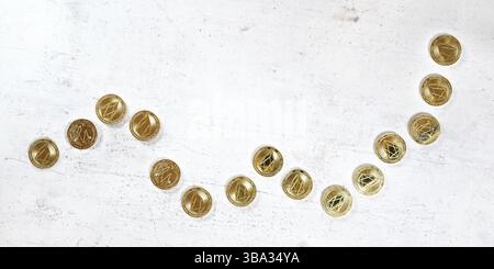 Top down view, white stone board desk with golden EOS cryptocurrency coins in shape of rising graph - bullish market illustration, Liptovsky Hradok, S Stock Photo