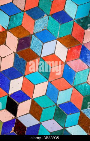 Colorful ceramic rhombus tiles creating a vibrant geometric pattern, forming an intriguing optical illusion that captivates the eye Stock Photo