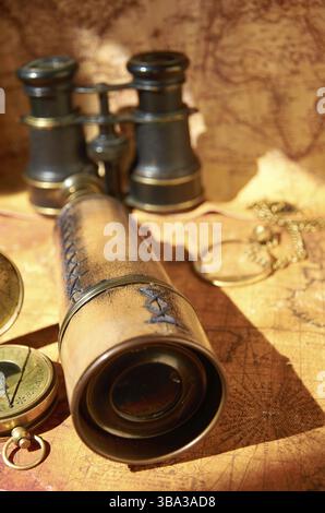 Binoculars And Telescope On Old Map Stock Photo - Alamy