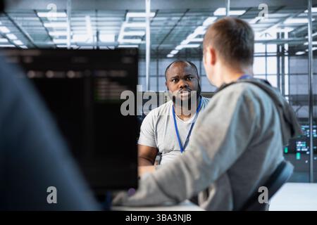Manager admonishing developer after making error damaging high tech data center. Supervisor scolding IT staff member after doing mistake in server room affecting supercomputers Stock Photo