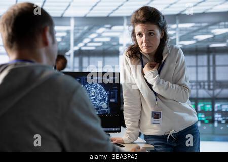 Team of engineers using machine learning to optimize data center operations, improving efficiency of infrastructure. Coworkers doing brainstorming, implementing server virtualization Stock Photo