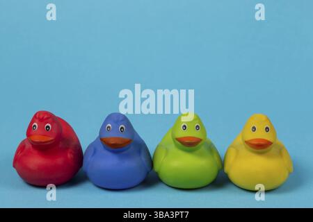 Multi-colored rubber ducks on a blue background Stock Photo