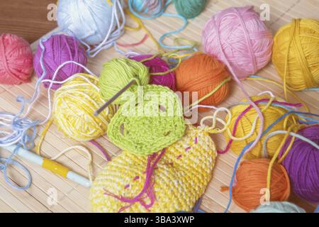 Colorful clews yarn and crochet hook on wooden background. Toned and processing photos Stock Photo