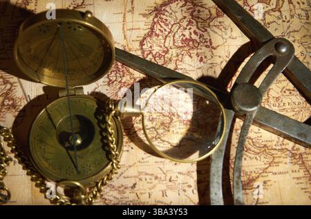 Old compass and magnifying glass lying on the map Stock Photo