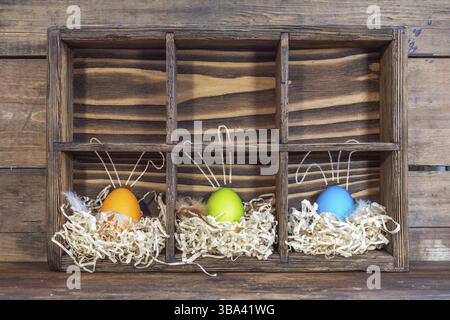 Easter eggs with bunny ears in the nests in cell boxes Stock Photo