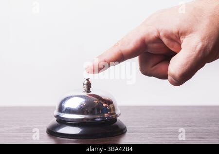 Close-up finger that presses of the service bell ring Stock Photo