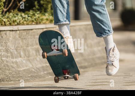 Skateboarding at city. Female, enjoyment. Hipster girl riding skate ...