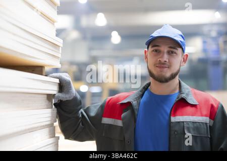 Belarus, Gomil. Wood processing plant. April 25, 2022.Close-up of a man worker in a woodworking plant. Portrait of a worker standing in a factory in a Stock Photo