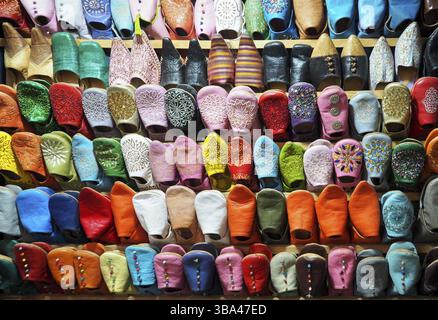 Handmade colourful babouche - leather slippers on display at traditional souk - street market in Morocco Stock Photo