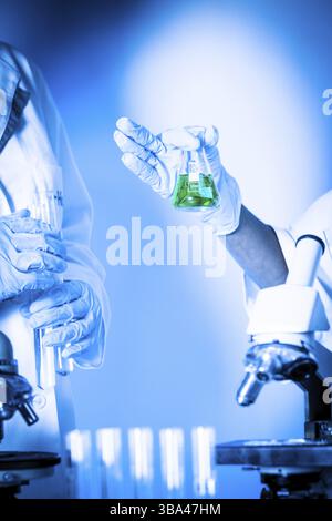 Two scientists in the chemical laboratory are doing experiments Stock Photo