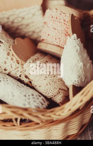 Vintage lace on the wooden bobbin in a basket Stock Photo