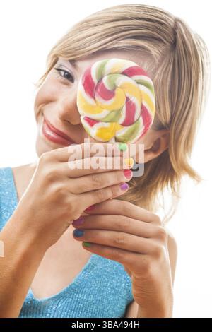 Funny teen with colored nails holding Colorful lollipop. Isolated on white background Stock Photo