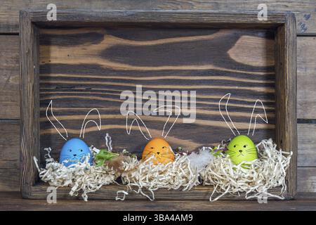 Easter eggs with bunny ears in the nests in boxes Stock Photo
