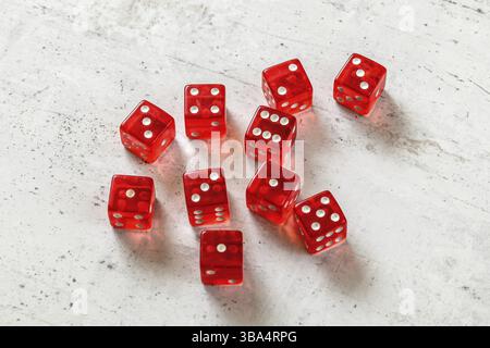 10 translucent red dices on white concrete board, Liptovsky Hradok, Slovakia, Europe Stock Photo