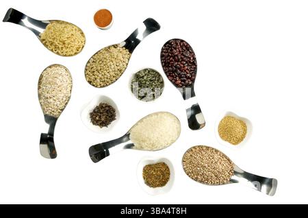 BEANS RICE BUCKWHEAT SEEDS LENTILS SPICES IN SPOONS ON THE ISOLATE Stock Photo