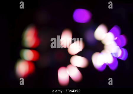 Multicolored defocused bokeh on a black background Stock Photo