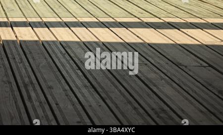 Regular exterior wooden board floor, sun casting shadow from side, Brno, Czech Republic, Europe Stock Photo