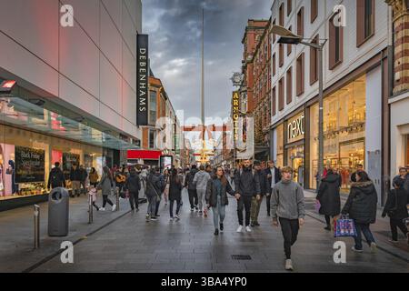 Dublin, November 2019 Henry Street decorated for Christmas with crowds of people enjoying shopping. The Spire on OConnell street visible in background Stock Photo