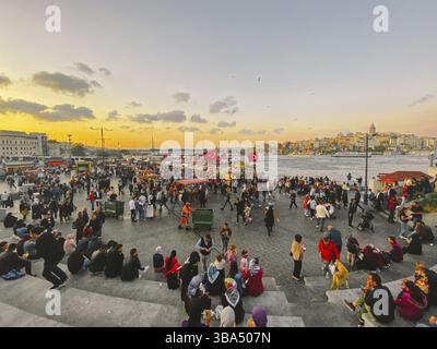 October 27, 2019. Eminonu square by sunset, Istanbul, in Turkey. People rest and socialize in a square near Galata Bridge, shopping and historic desti Stock Photo