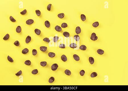 Top down view, chocolate cornflakes scattered on yellow board, Liptovsky Hradok, Slovakia, Europe Stock Photo