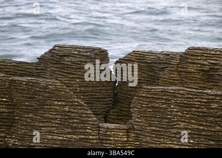 background of Limestone rocks and ocean waves at Punakaiki, New Zealand Stock Photo