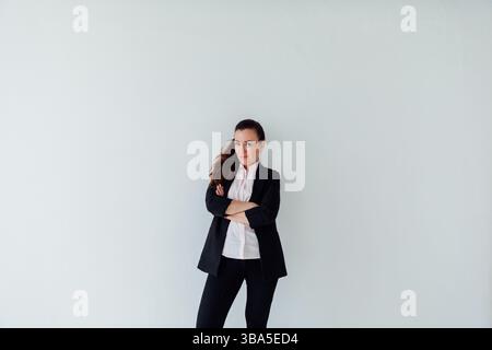 Brunette woman in business suit posing on white background Stock Photo
