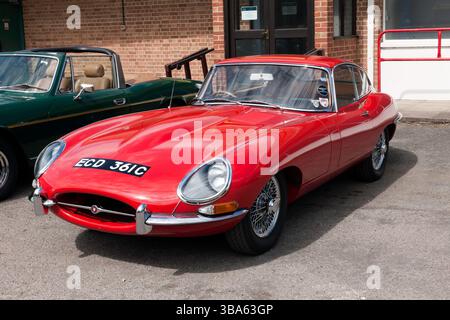 Three-quarters front view of a 1965, Red, Jaguar E-Type, on display at the Brooklands Museum during the Easter Classic Gathering Stock Photo