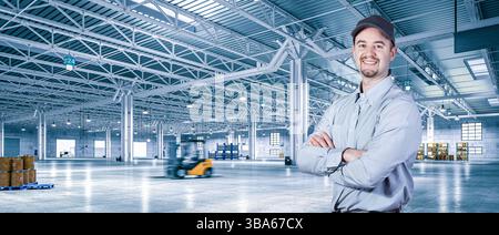 Supervisor smiling with crossed arms in warehouse with forklift moving Stock Photo