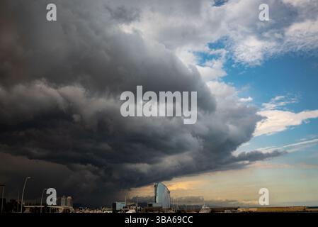 Dark storm clouds gather over Barcelona’s coastline as an intense weather front approaches the city. Stock Photo