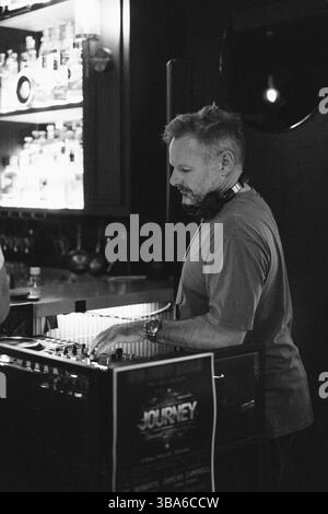 DJ amidst friends enjoying at nightclub Stock Photo