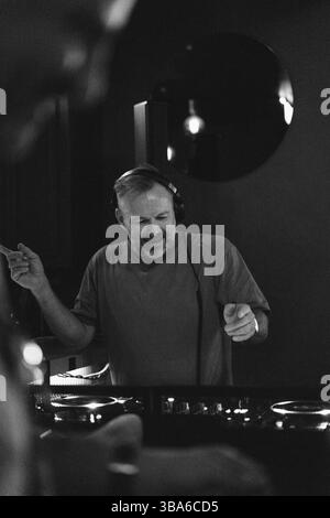 DJ amidst friends enjoying at nightclub Stock Photo