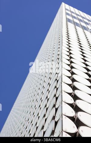 Modern geometric building white circle pattern, blue sky background Stock Photo