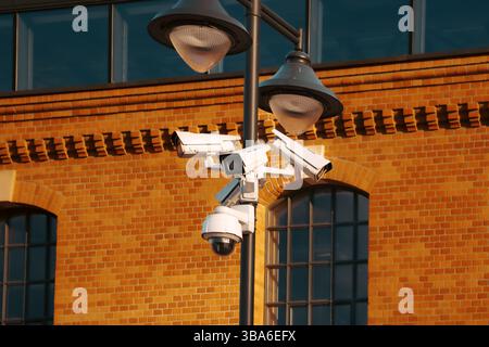 Multiple surveillance cameras on metal pole urban residential neighborhood safety monitoring system public security equipment outdoor CCTV Stock Photo