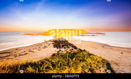 Scenic view of Windang beach against sky during sunset Stock Photo