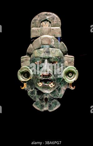 Frontal view of a royal Mayan funeral mask against a black background, Calakmul, Mexico Stock Photo