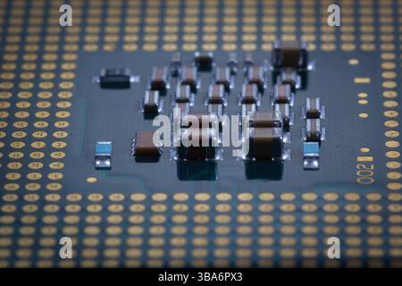 Close-up image showcasing detailed components on a microchip, illustrating intricate electronic design principles and surface-level microengineering i Stock Photo
