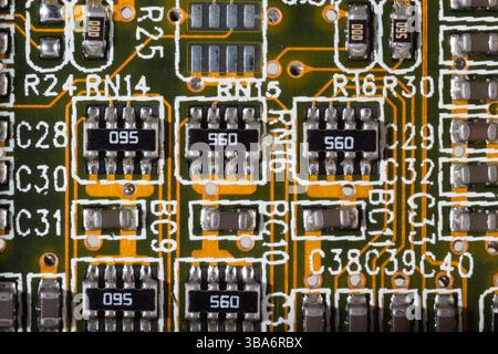 A macro shot showcasing electronic components meticulously arranged on a circuit board. The image highlights the intricate design, including resistors Stock Photo