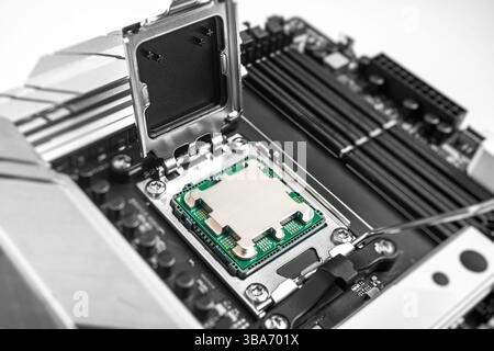 A central processing unit is securely seated in a motherboard socket Stock Photo