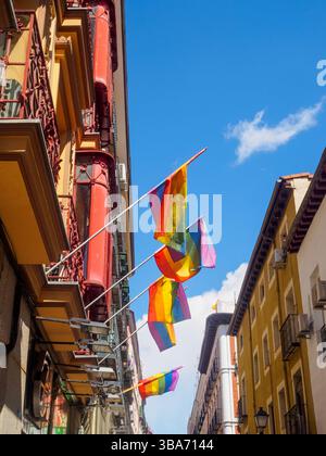 A street in the Chueca neighborhood adorned with Pride flags for the Gay Pride Day celebration. Stock Photo