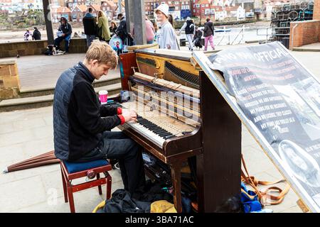 Pianist, piano player, playing piano, playing piano outside, pianoist, musician, player, piano, piano playing, Whitby, Yorkshire, UK, England Stock Photo