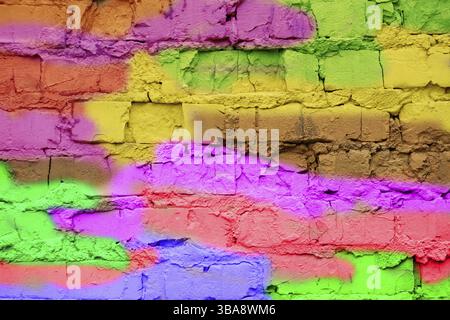 Multicoloured brick wall in close-up. Bright fun background in the style of graffiti Stock Photo