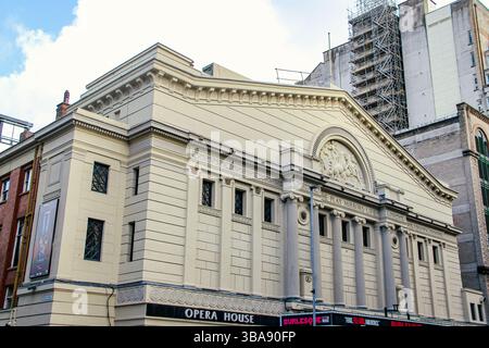 Neoclassical building with columns and triangular pediment, a cultural landmark. View of Opera House Manchester from Byrom St. and Quay St. on a sunny Stock Photo