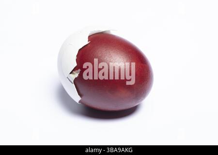 Classic Easter egg painted with onion skins Close-up on white background Stock Photo