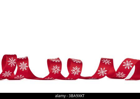 Christmas red ribbon twisted against a white background Stock Photo