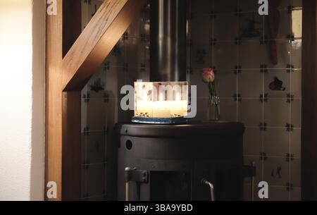 Christmas candle between mirrors on a stove Stock Photo