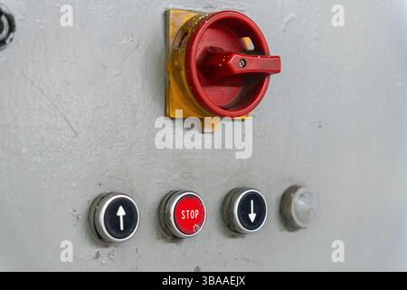 Emergency Stop installed at line conveyor in manufacturing plant. START - STOP button for industrial machine. Industrial and factory concept. Stock Photo