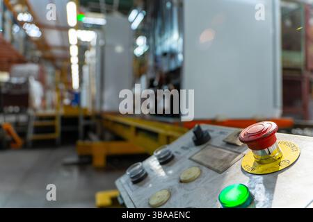Emergency Stop installed at line conveyor in refrigerator manufacturing plant. START - STOP button for industrial machine. Industrial and factory conc Stock Photo