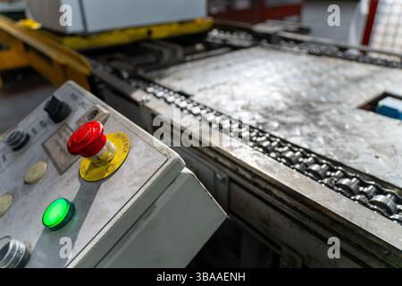 Emergency Stop installed at line conveyor in refrigerator manufacturing plant. START - STOP button for industrial machine. Industrial and factory conc Stock Photo